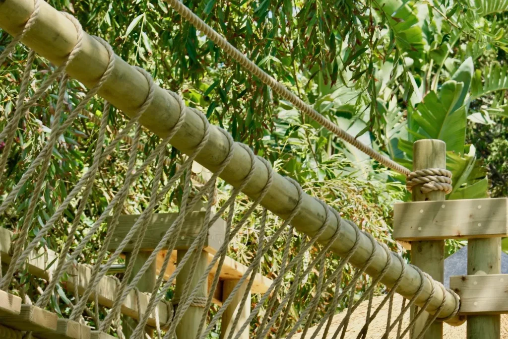 Fixed Beam Rope Bridge and rope-work with tree in background.