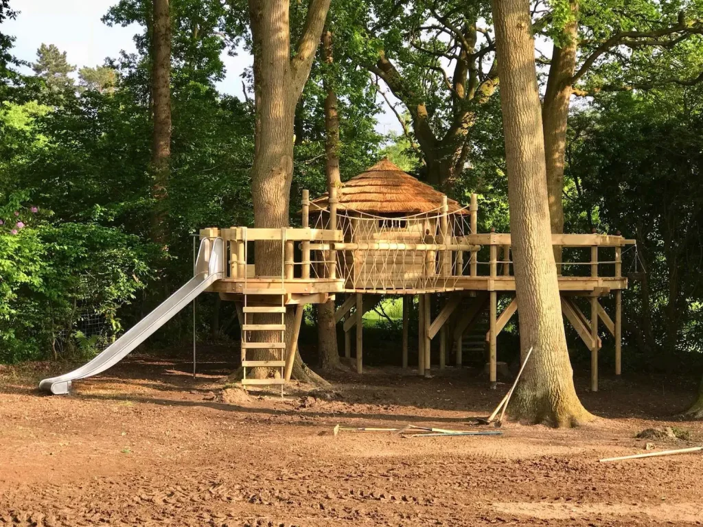 Garden Treehouse project set into two trees with two decks, Rope Ladder and stainless steel Slide