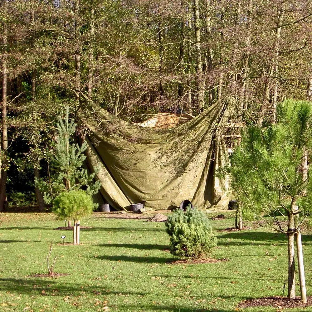 Garden Treehouse hidden behind a tarpaulin because it is a Christmas present.