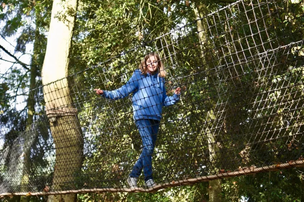 Girl walking in a Treetop Walkway high in the tree canopy