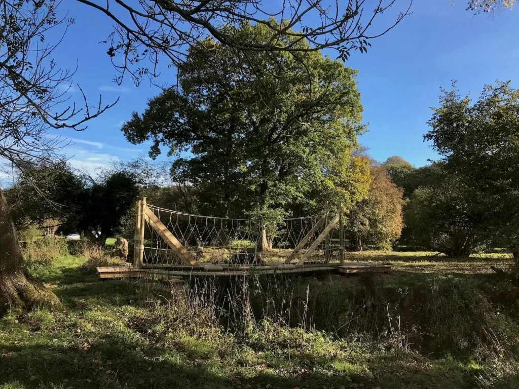 Rope Bridge across an ancient lock in English woodland countryside
