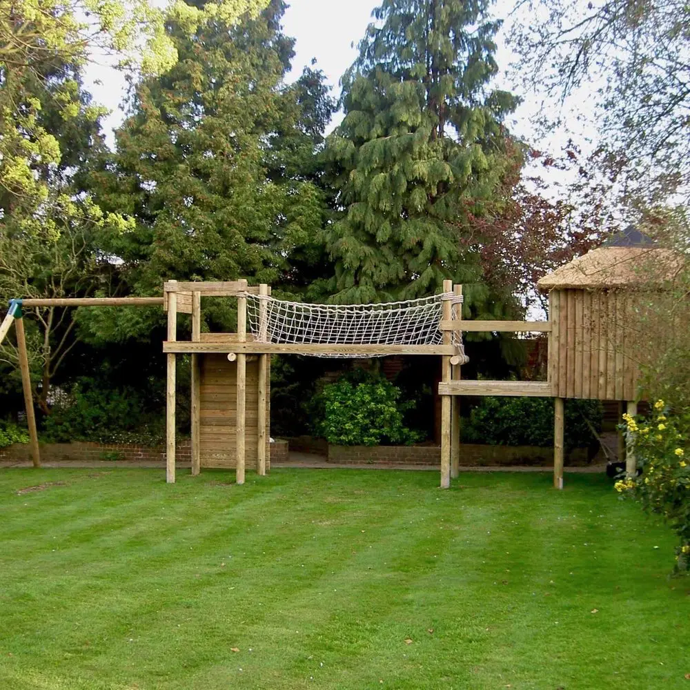 Shall garden play-set Treehouse with add-on deck, Scramble Net Bridge, Play-Tower with Climbing Wall and Swing Set.