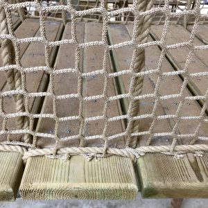 Square mesh safety netting added to side of timber slat Rope Bridge for balustrade.