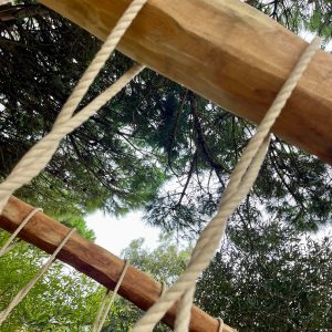 Peeled hardwood Robinia beam with Rope Bridge rope work.