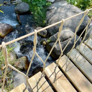 Rope Bridge with rope work balustrade over a river in Utah.
