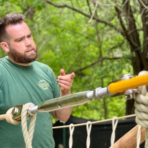 Rope Bridge installer pointing to a stainless steel Rigging Screw on a Rope Bridge.