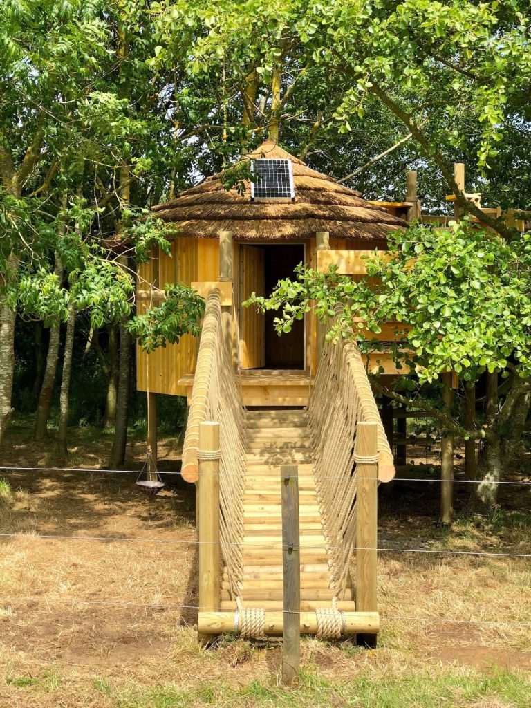 Treehouse set into woods with Log Rope Bridge entrance leading to a Treehouse Deck Platform...the kids are absolutely delighted.