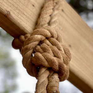 Large rope knot around a balustrade timber beam.
