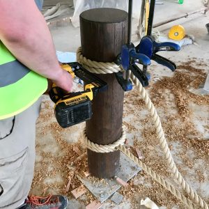 Installing 24mm polyhemp hemptex rope to round timber balustrade posturing a stapler machine and clamps.
