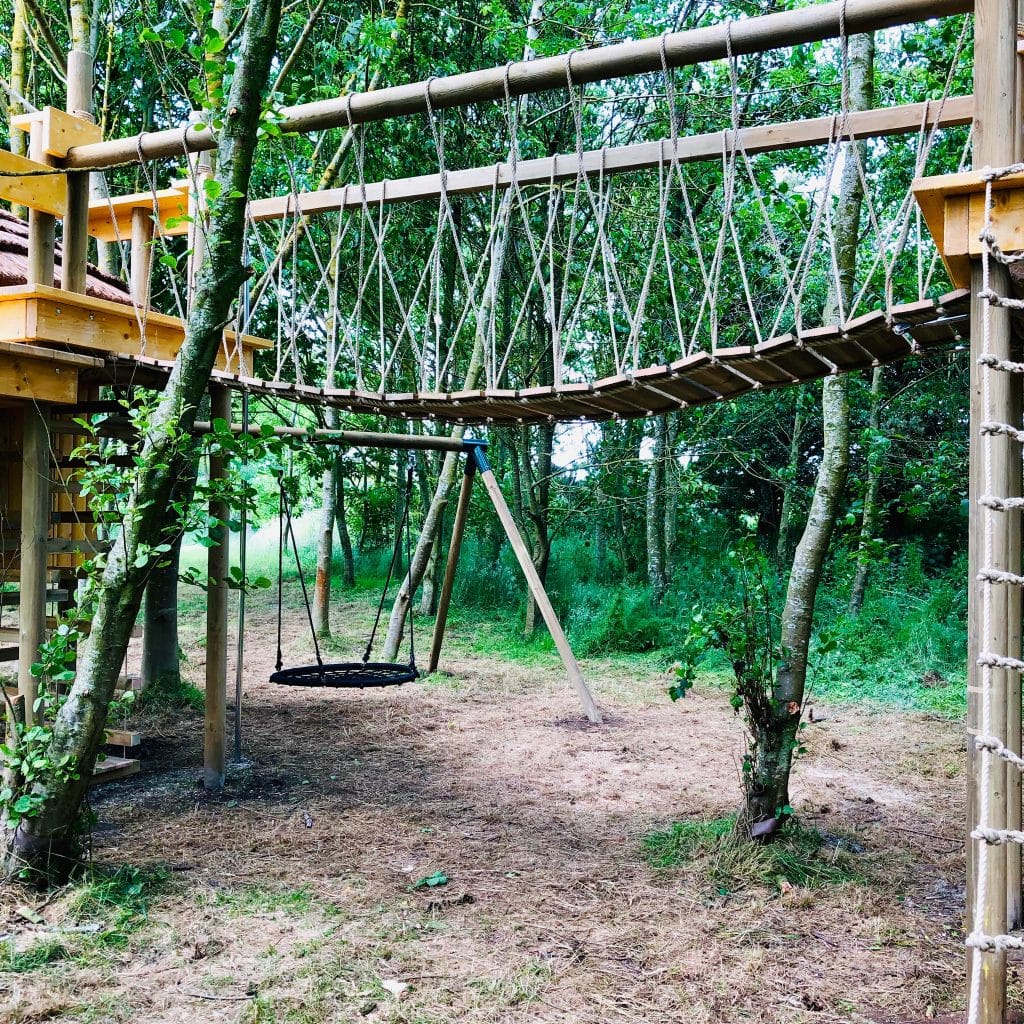 A rope bridge and nest swing in a large wooded garden in the Scottish county of Fife.